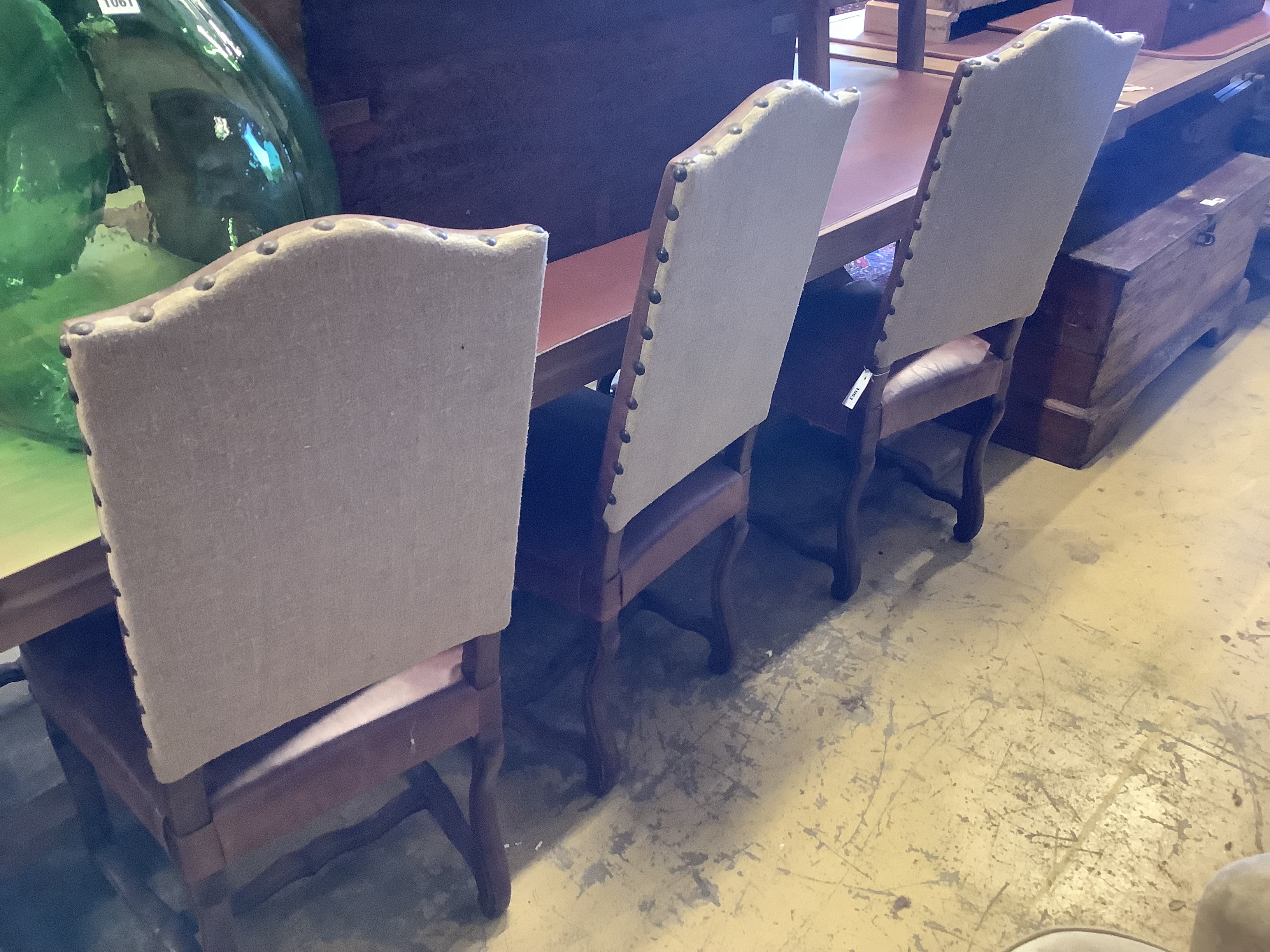 A set of six French leather high back dining chairs
